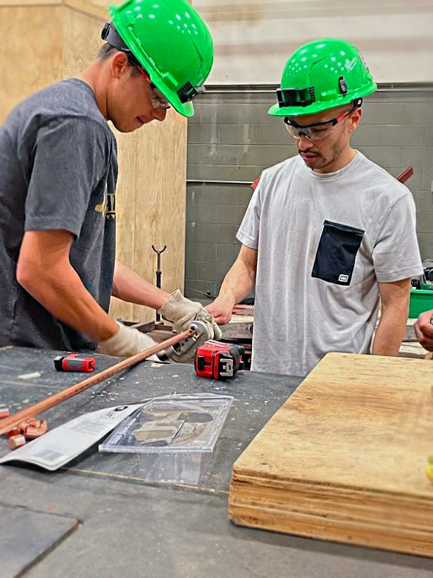 Carson and Dat working on their pipefitting project